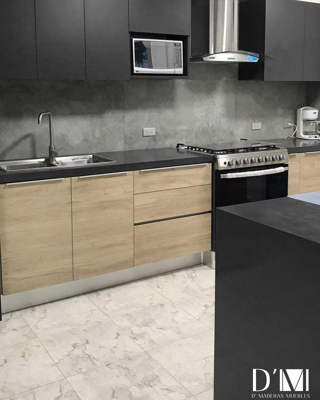 Cocina a medida con frentes en roble claro, tope oscuro y campana de acero, fabricada e instalada por D'Maderas